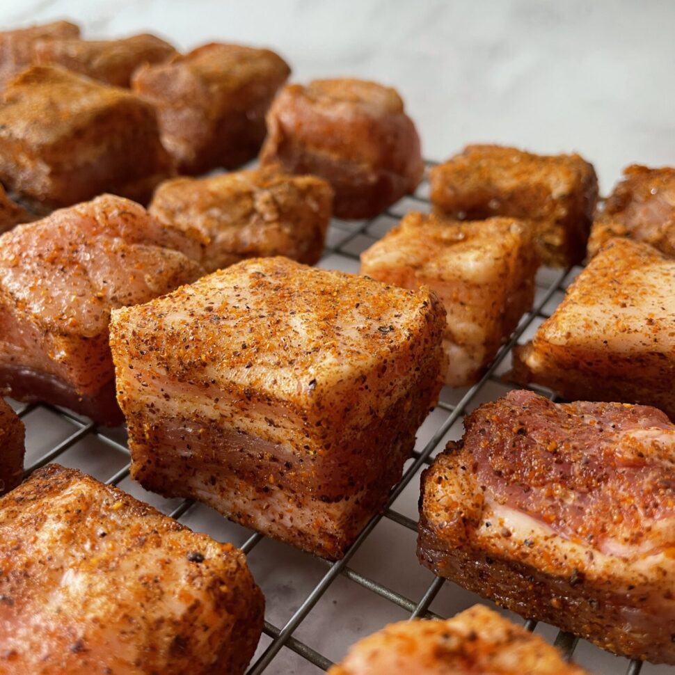 Pork belly burnt ends are made by first cubing the pork into 1 inch cubes.